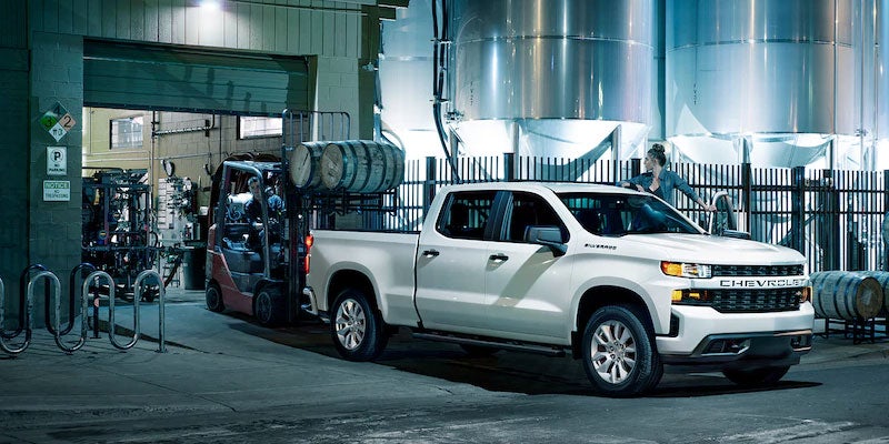 Chevrolet Silverado pickup truck parked outside industrial building