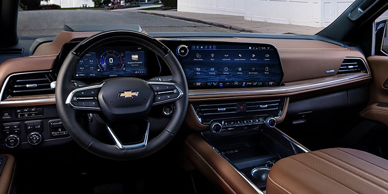 Interior of a Chevrolet with a digital instrument cluster, large infotainment screen, and brown/black dashboard.
