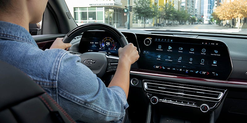 Driver using a Chevrolet vehicle's digital dashboard and touchscreen display