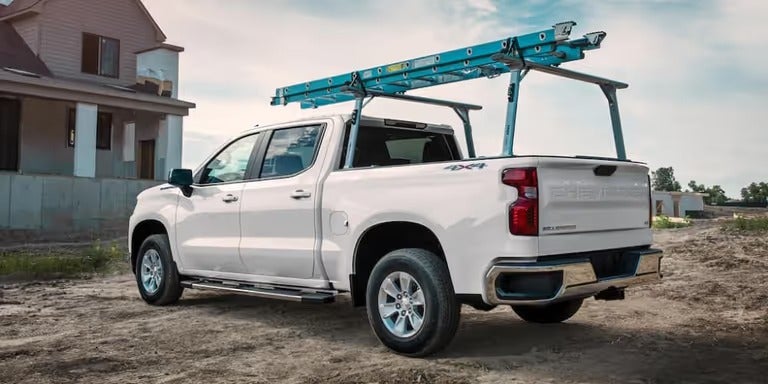 Chevrolet Silverado with ladder rack at construction site